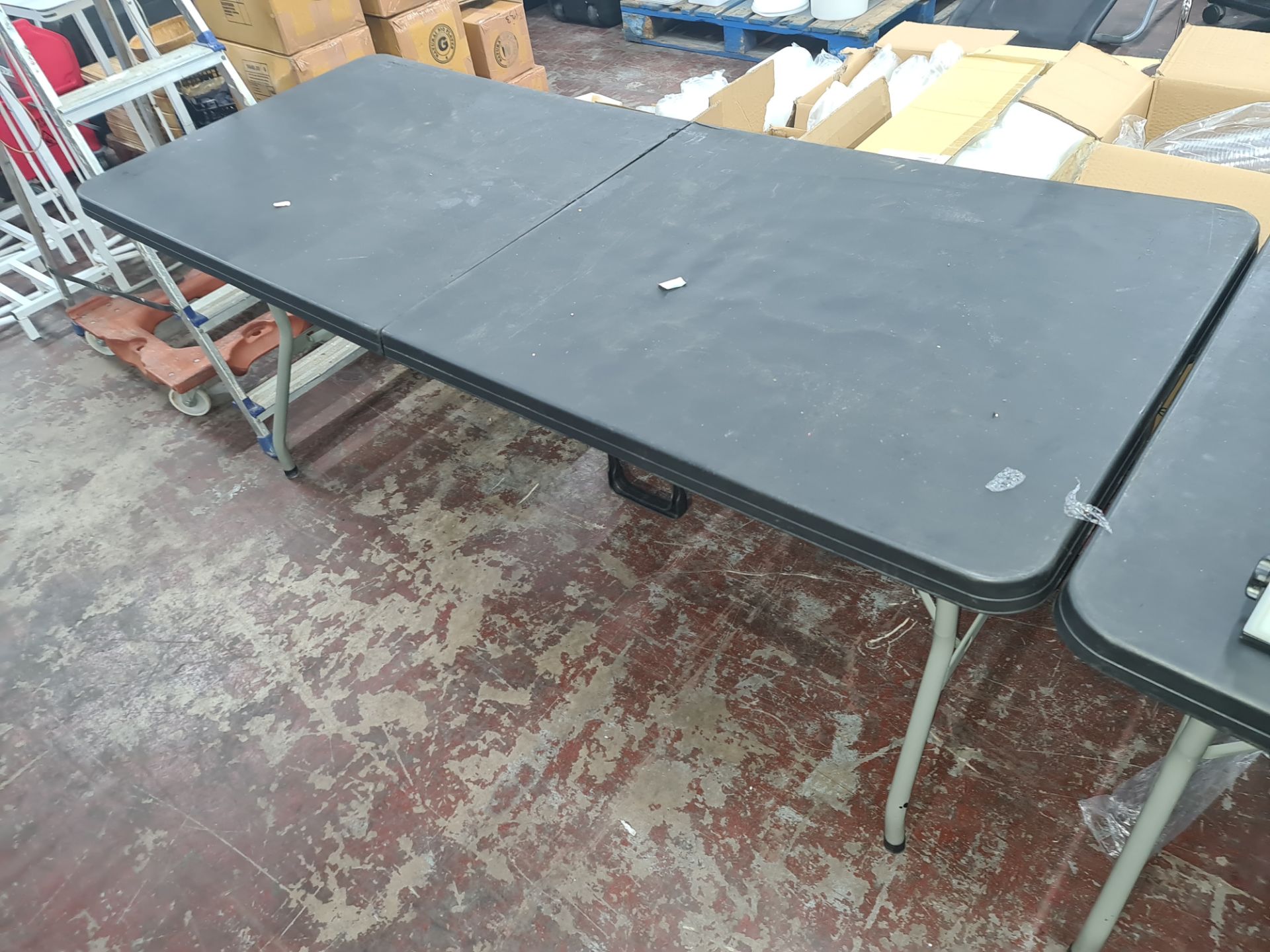 4 off heavy-duty folding trestle tables with plastic tops & metal legs, incorporating a carry handle