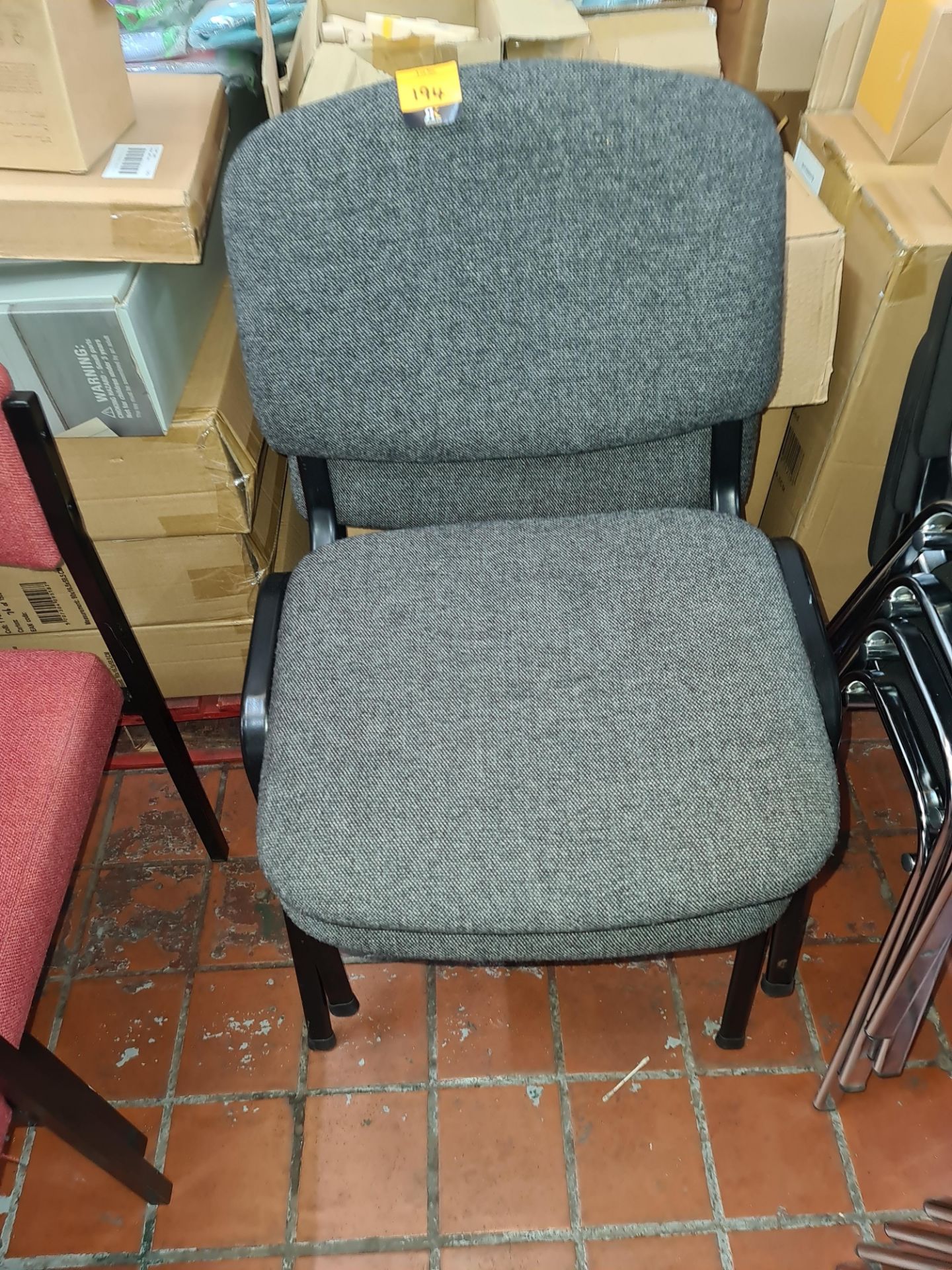 Pair of matching stacking stand chairs in grey fabric on black frames