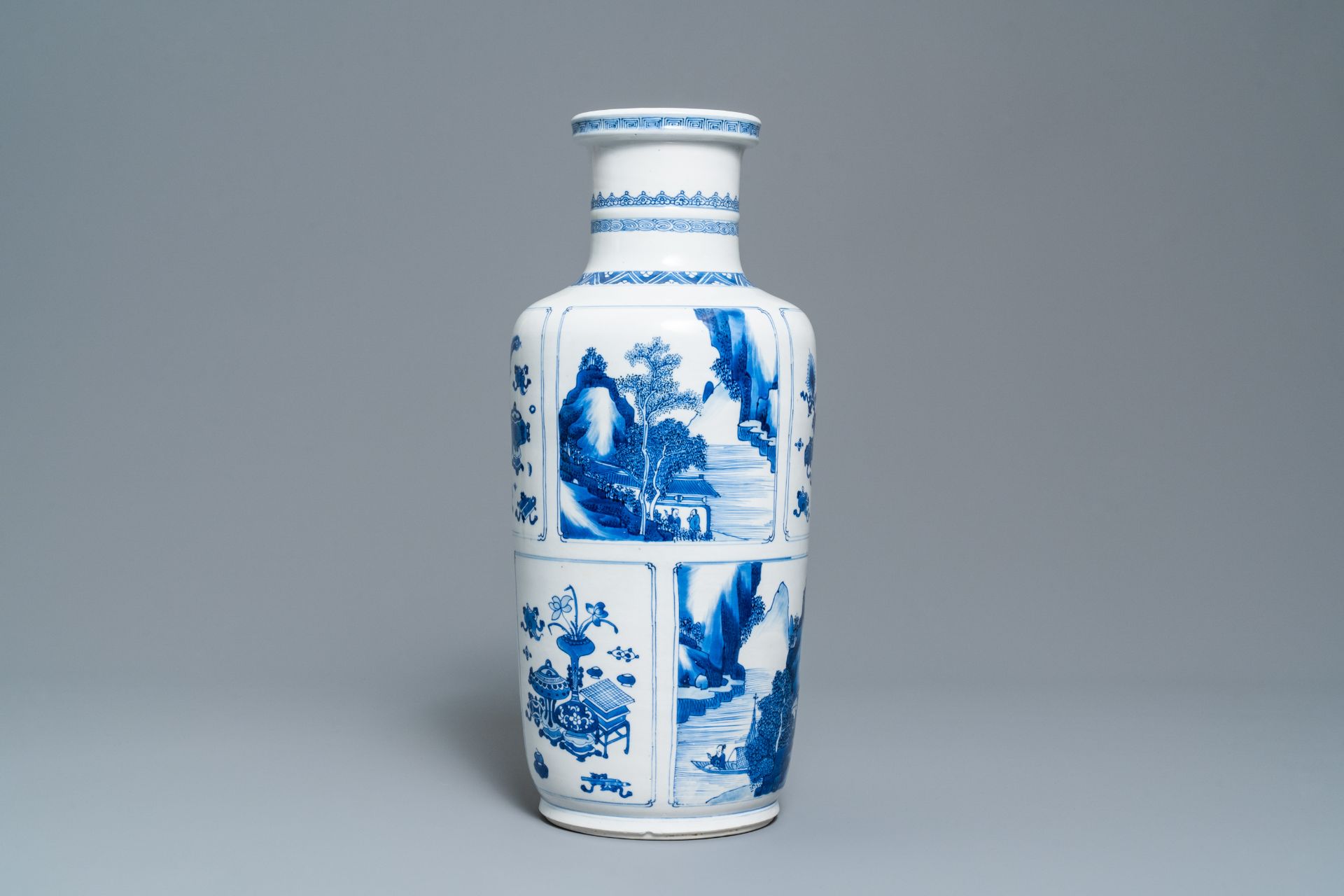 A Chinese blue and white 'antiquities and landscapes' rouleau vase, Kangxi