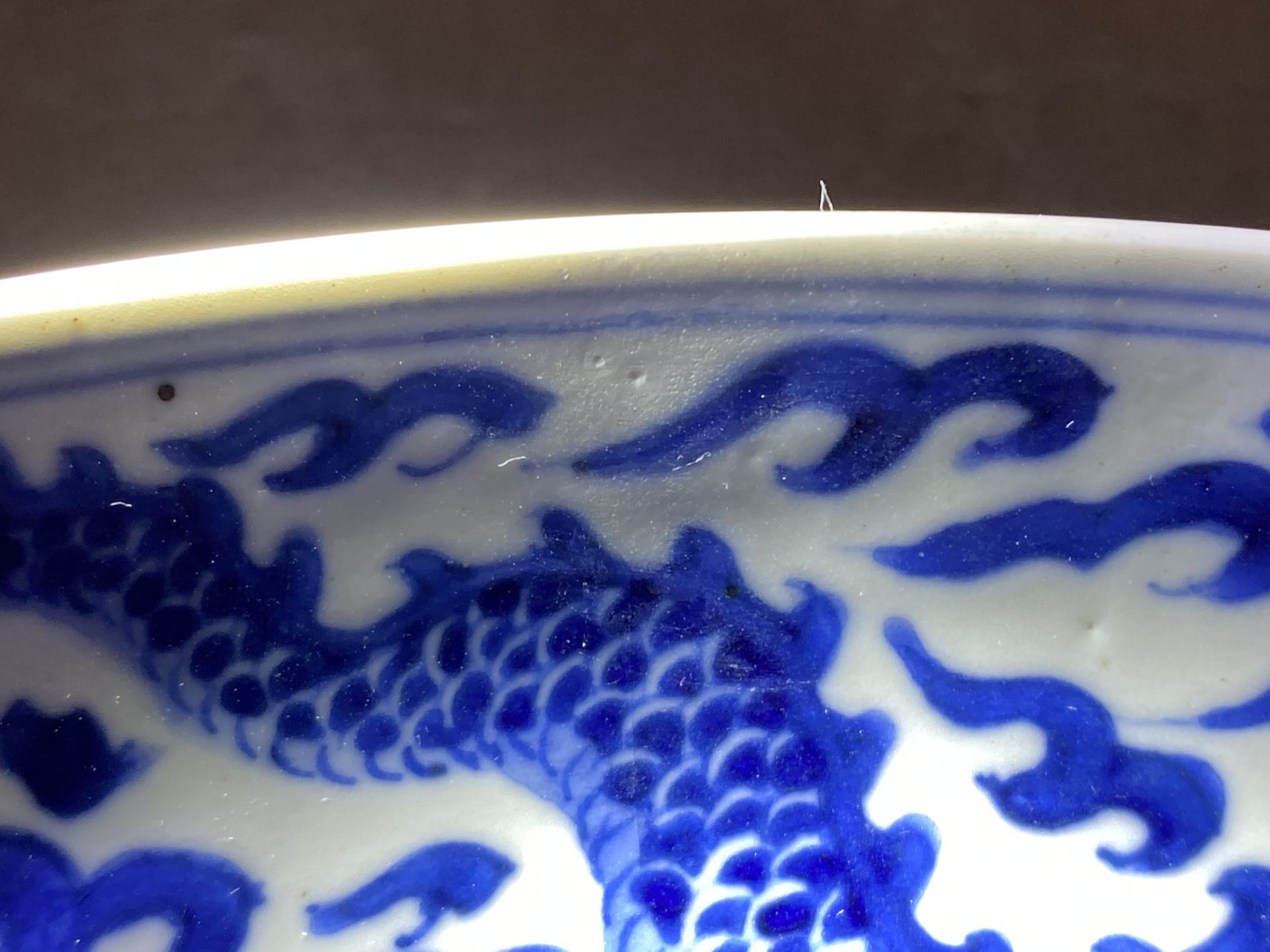 A Chinese blue and white 'dragon' dish, Kangxi mark and of the period - Image 9 of 12