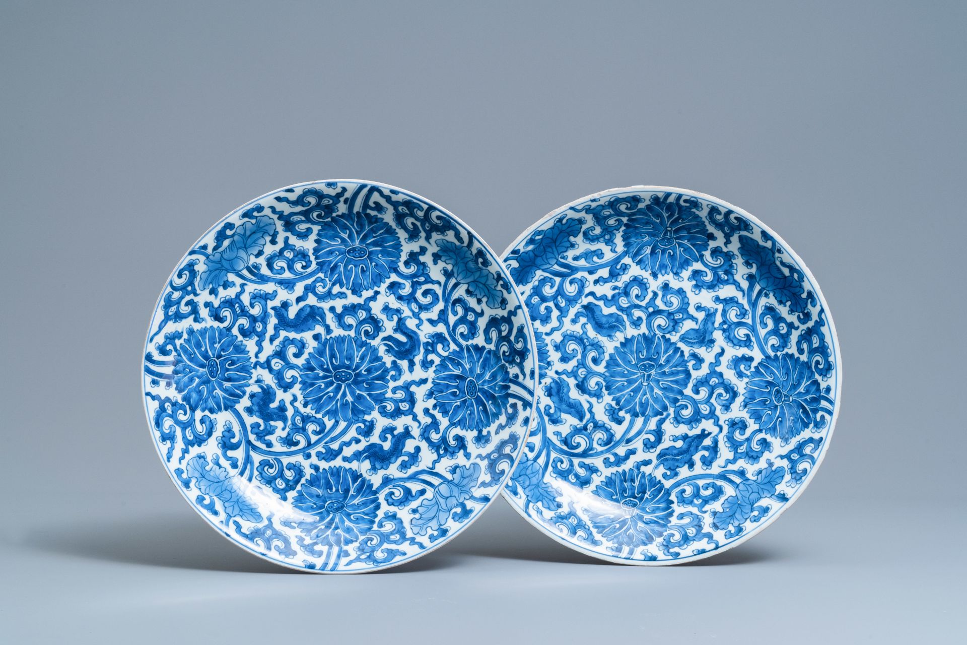 A pair of Chinese blue and white 'lotus scroll' chargers, Kangxi