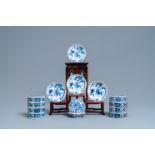 A pair of Chinese blue and white four-tier stacking boxes, a seal paste box & four saucers, 19th C.