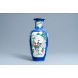 A Chinese famille verte powder blue-ground vase, 19th C.
