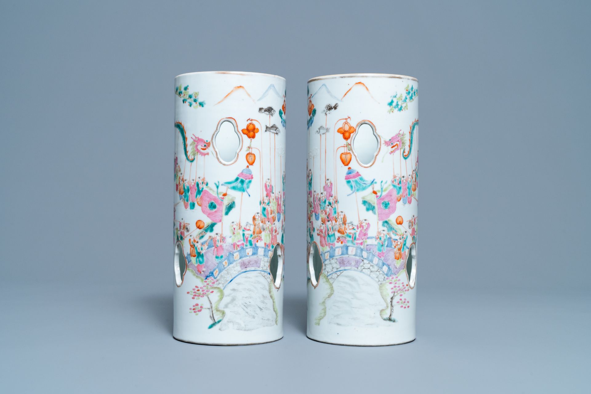 A pair of reticulated Chinese famille rose '100 boys' hat stands, Qianlong mark, 19th C.