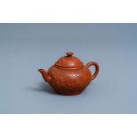 A Chinese Yixing stoneware teapot and cover with applied and impressed design, Kangxi