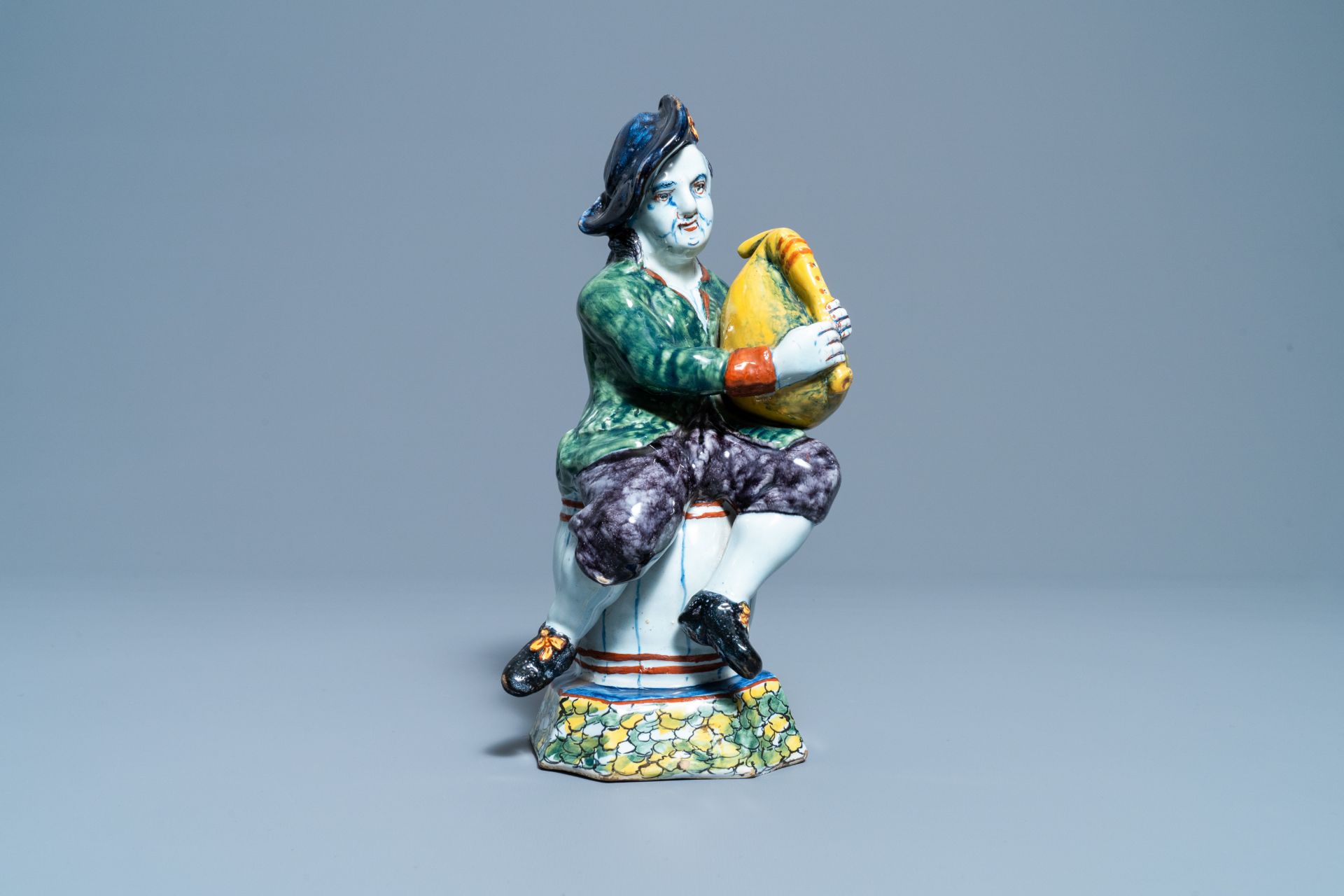 A polychrome Dutch Delft figure of a bagpipe player, 18th C. - Image 3 of 9