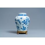 A Chinese blue and white vase on a gilt bronze foot, Kangxi