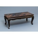 A Chinese rectangular lacquered wood table for the European market, 19th C.