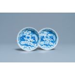 A pair of Chinese blue and white 'dragon' saucers, Kangxi mark, 19th C.