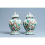 A pair of Chinese famille verte 'dragon' vases and covers, 19th C.