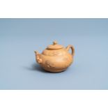 A bichrome Chinese Yixing stoneware teapot and cover with applied design, Kangxi