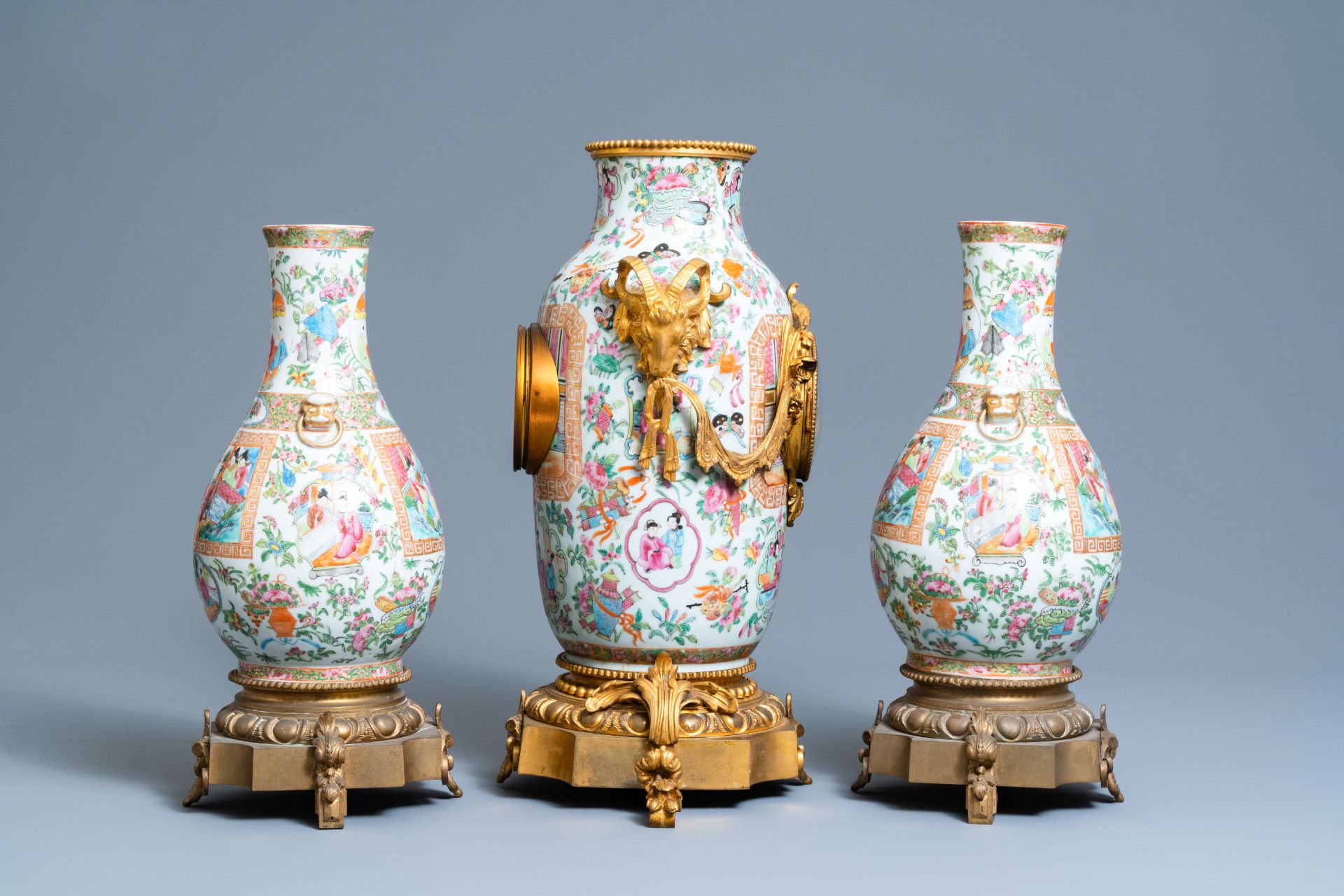 A Chinese gilt bronze-mounted three-piece Canton famille rose clock garniture, 19th C. - Image 2 of 7