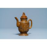 A Chinese brown-glazed relief-decorated teapot and cover, 18/19th