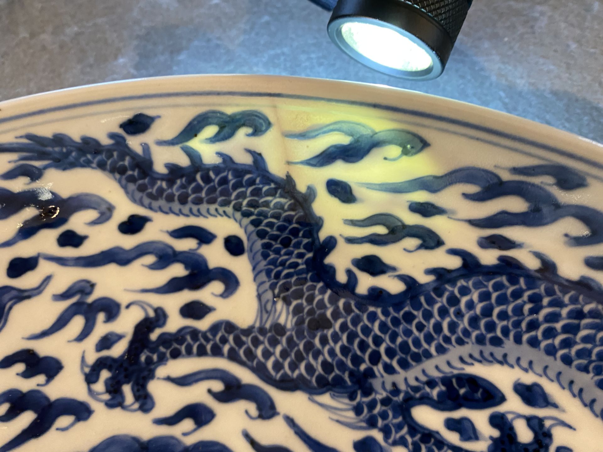 A Chinese blue and white 'dragon' dish, Kangxi mark and of the period - Image 4 of 12