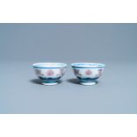 A pair of Chinese blue, white and copper red 'bajixiang' tea bowls, 4-character mark, 19/20th C.