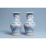 A pair of Chinese famille rose 'court scene' vases, 19th C.