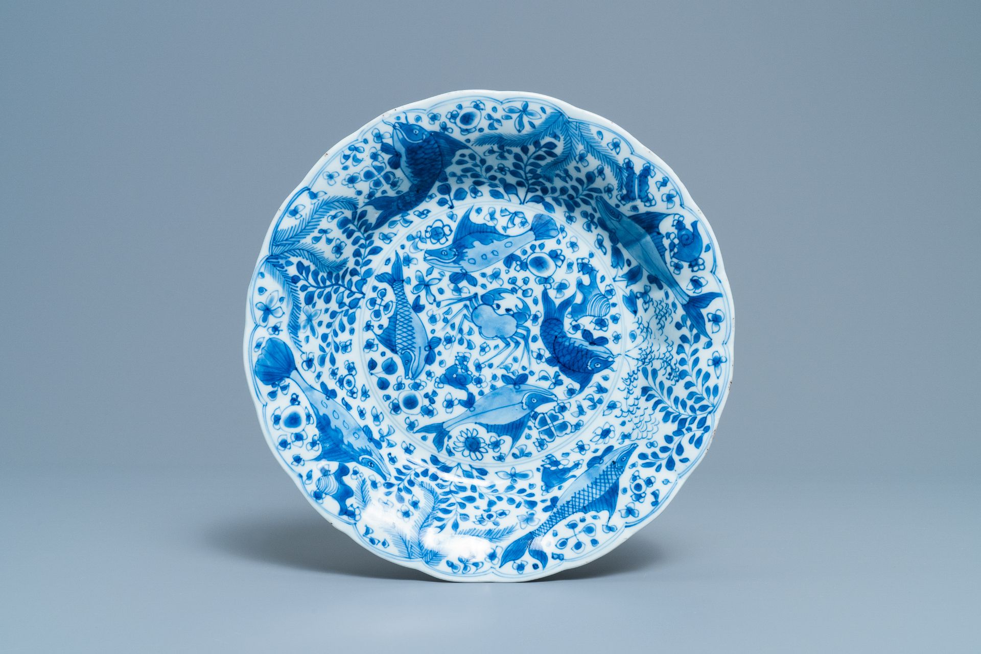 A Chinese blue and white lobed dish with fish, Kangxi