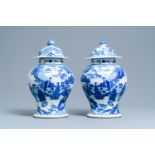 A pair of Chinese blue and white vases and covers with figures in a landscape, 19th C.