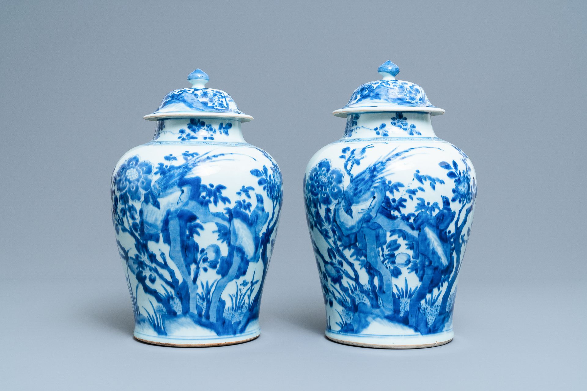 A pair of Chinese blue & white baluster vases & covers with birds, Kangxi