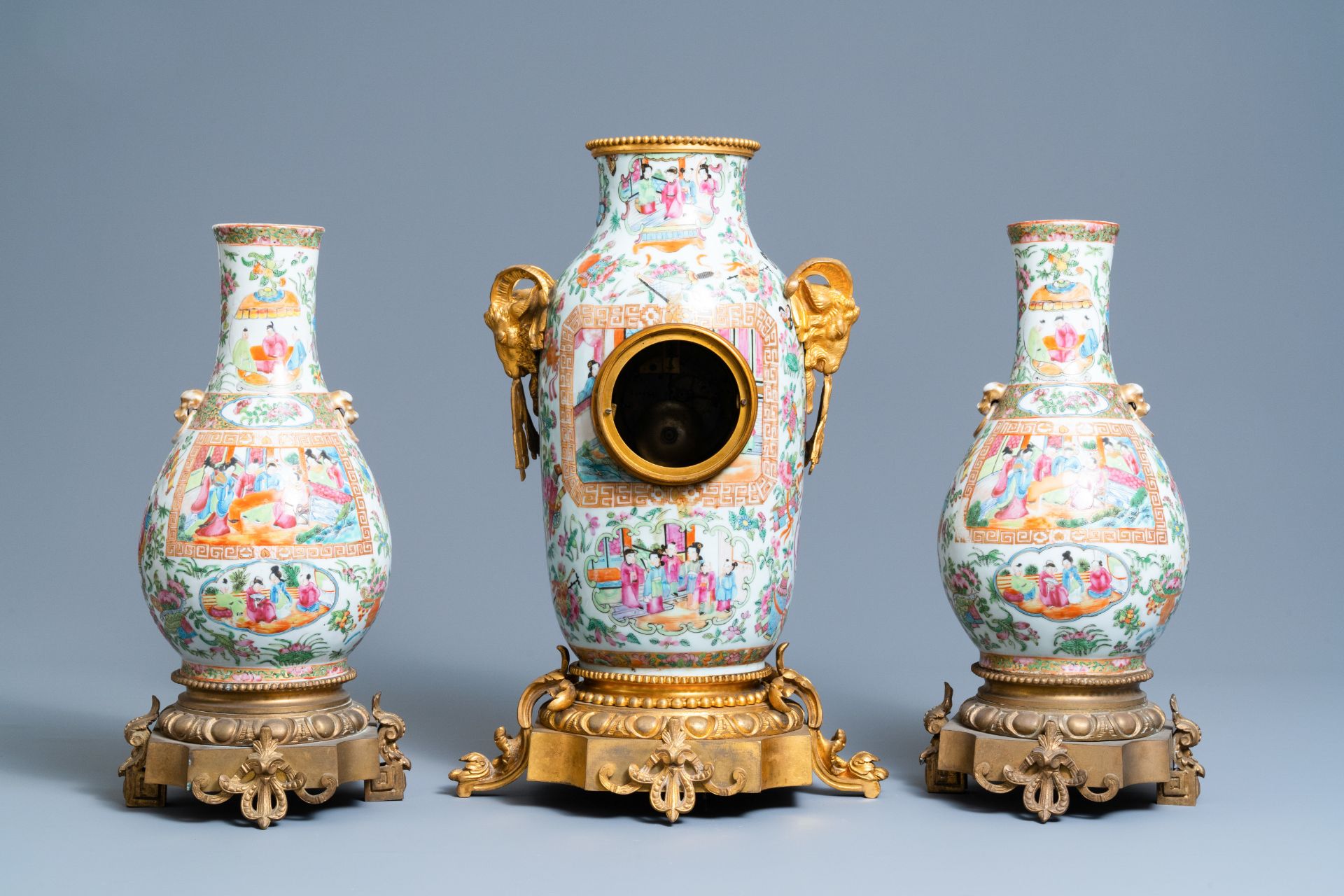 A Chinese gilt bronze-mounted three-piece Canton famille rose clock garniture, 19th C. - Image 3 of 7