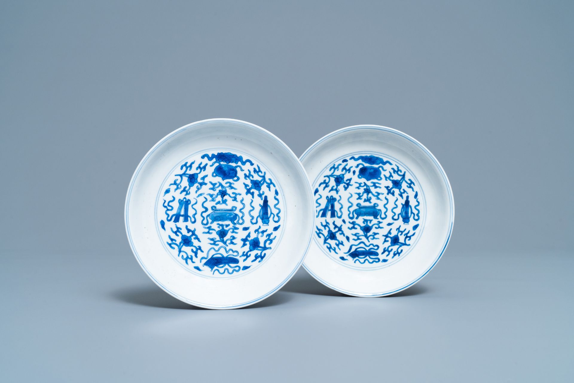 A pair of Chinese blue and white plates with taoist symbols, Kangxi mark & period