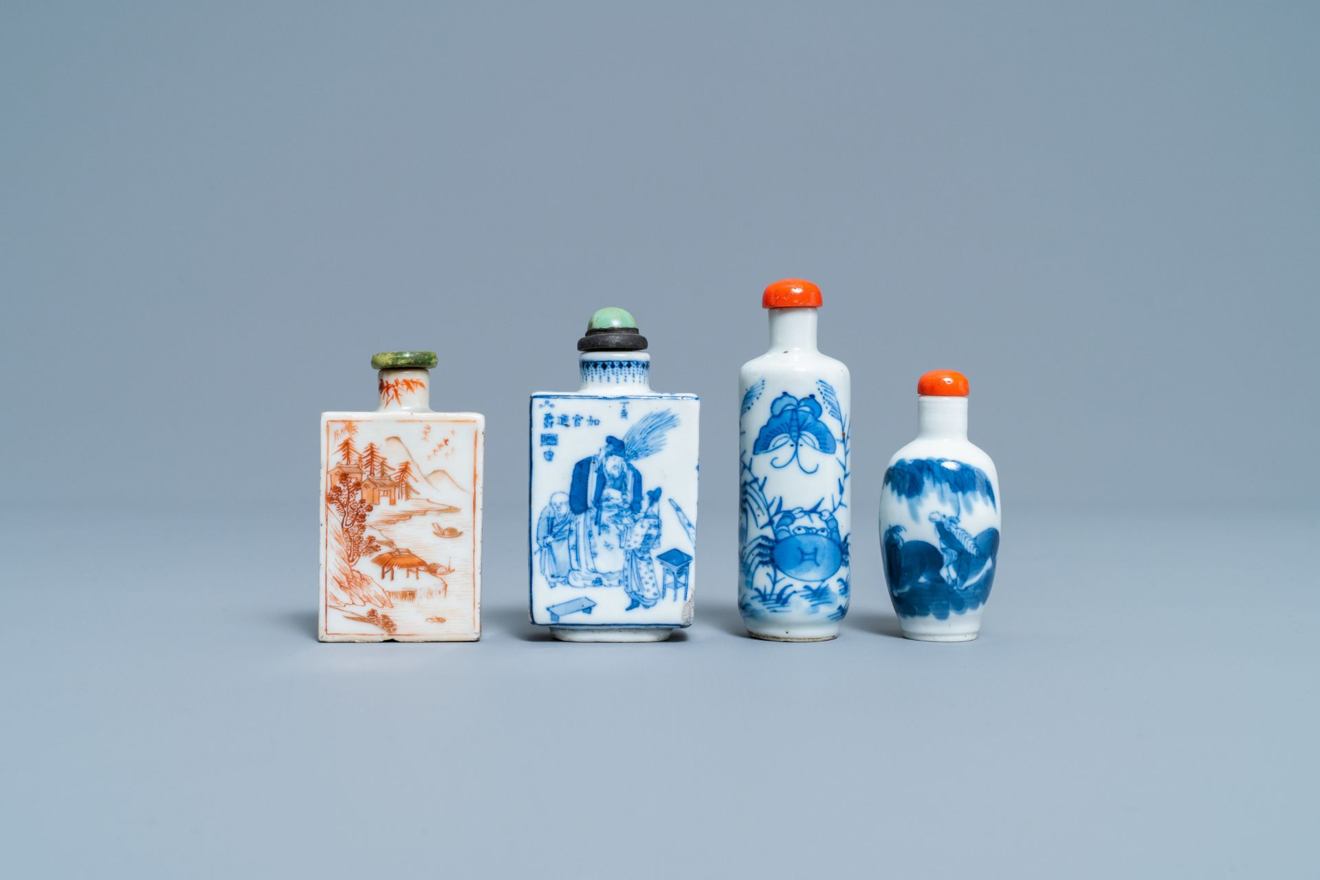 Four Chinese blue and white and iron-red snuff bottles, 19/20th C.