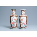 A pair of Chinese famille rose rouleau vases, 19th C.