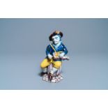 A polychrome Dutch Delft figure of a hurdy-gurdy player, 18th C.