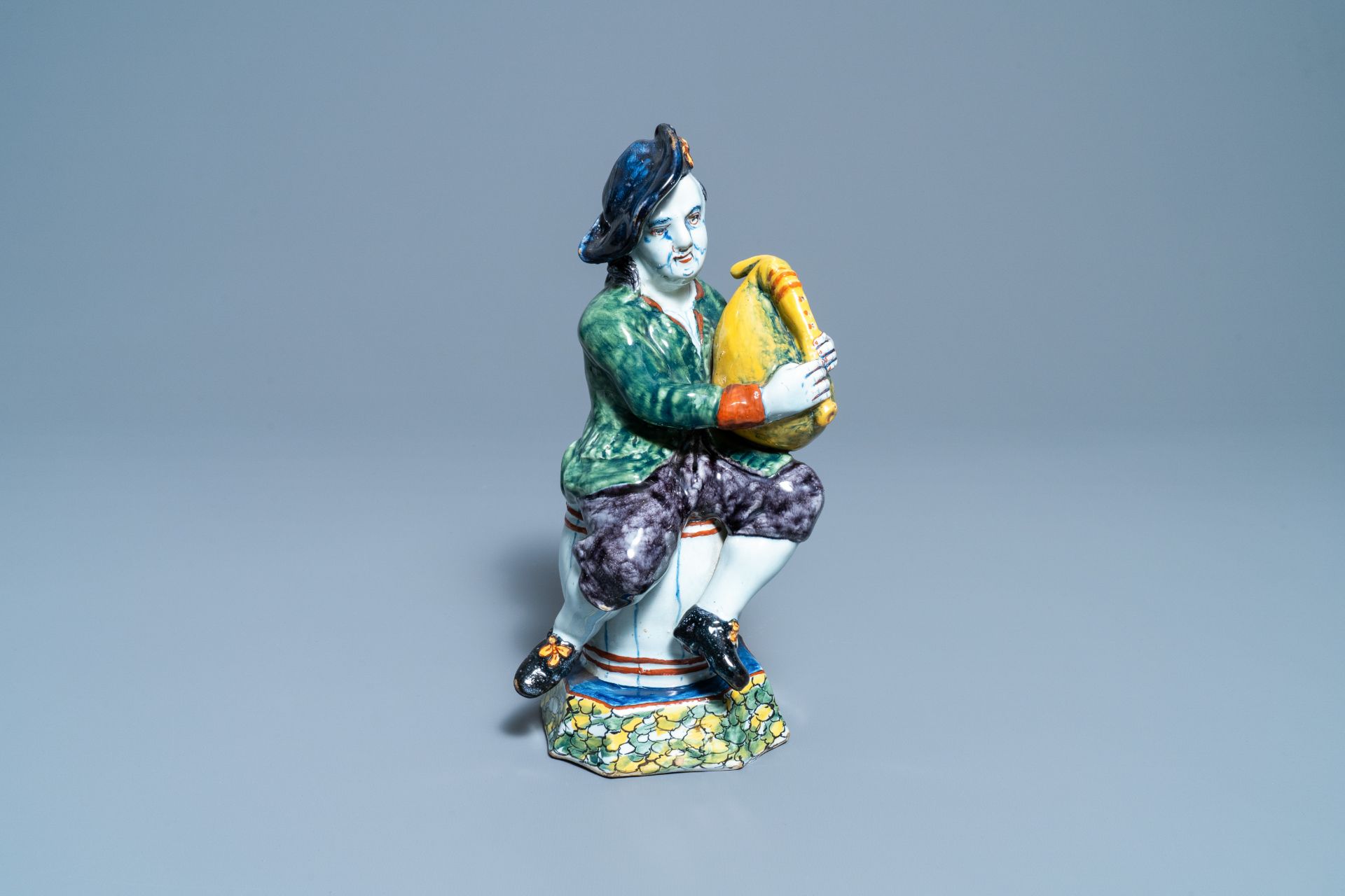 A polychrome Dutch Delft figure of a bagpipe player, 18th C. - Image 2 of 9