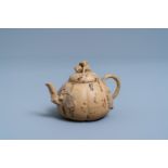 A bichrome Chinese Yixing stoneware teapot and cover with applied floral design, 19th C.