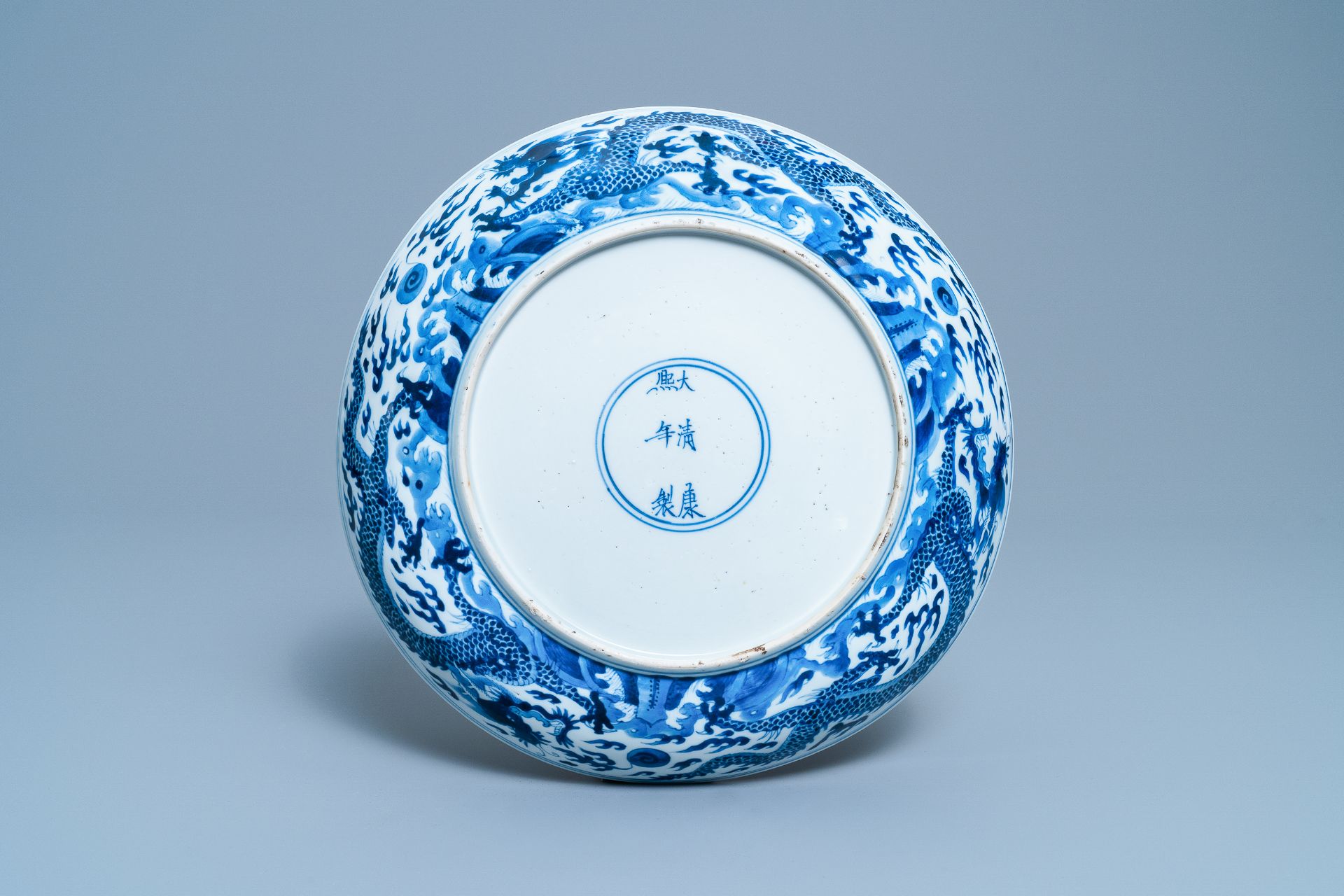 A Chinese blue and white 'dragon' dish, Kangxi mark and of the period - Image 2 of 12