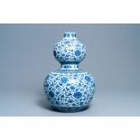 A large Chinese blue and white double gourd vase with floral scrolls, 19/20th C.