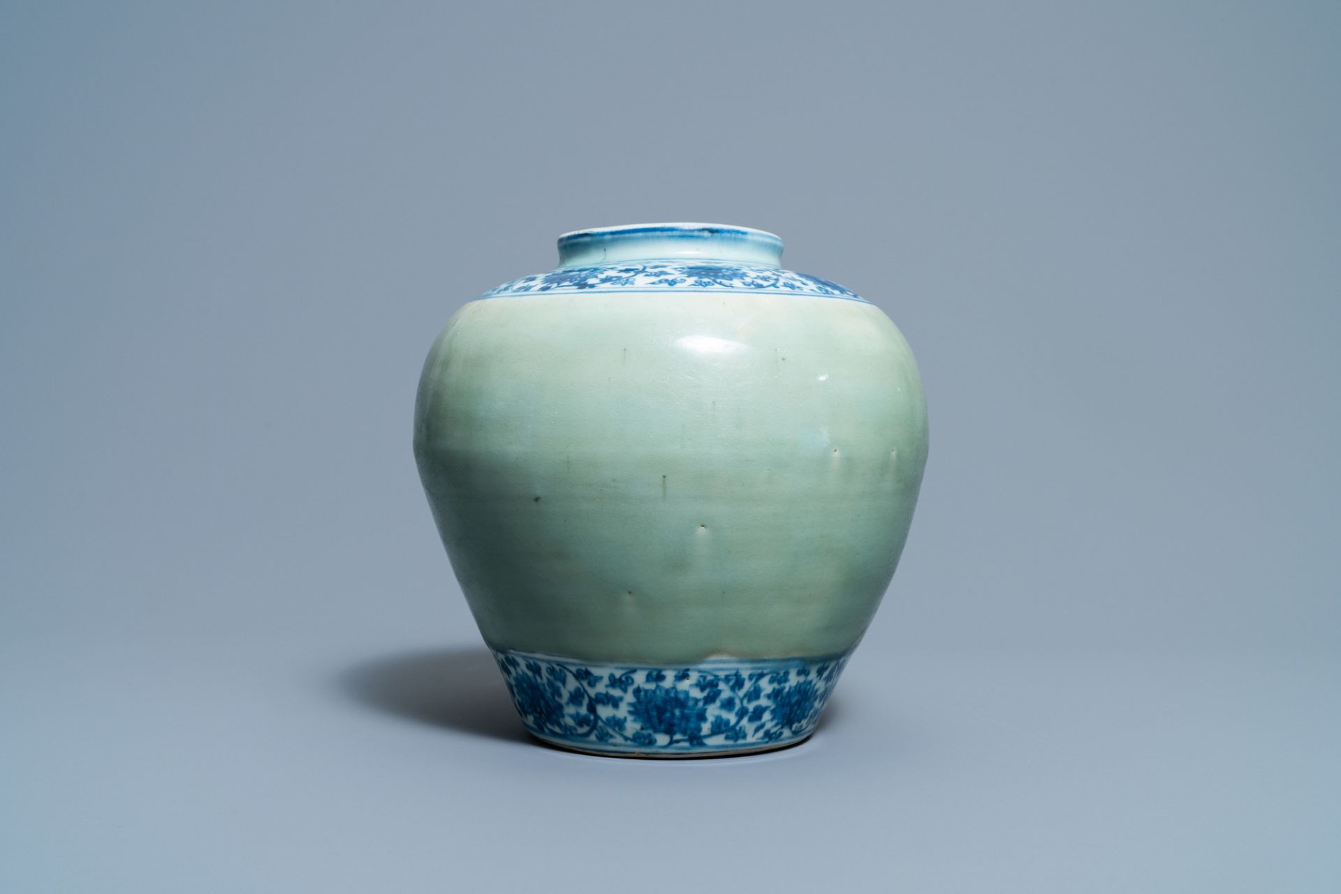 A Chinese celadon-ground and blue and white 'lotus scroll' jar, Ming - Image 2 of 7