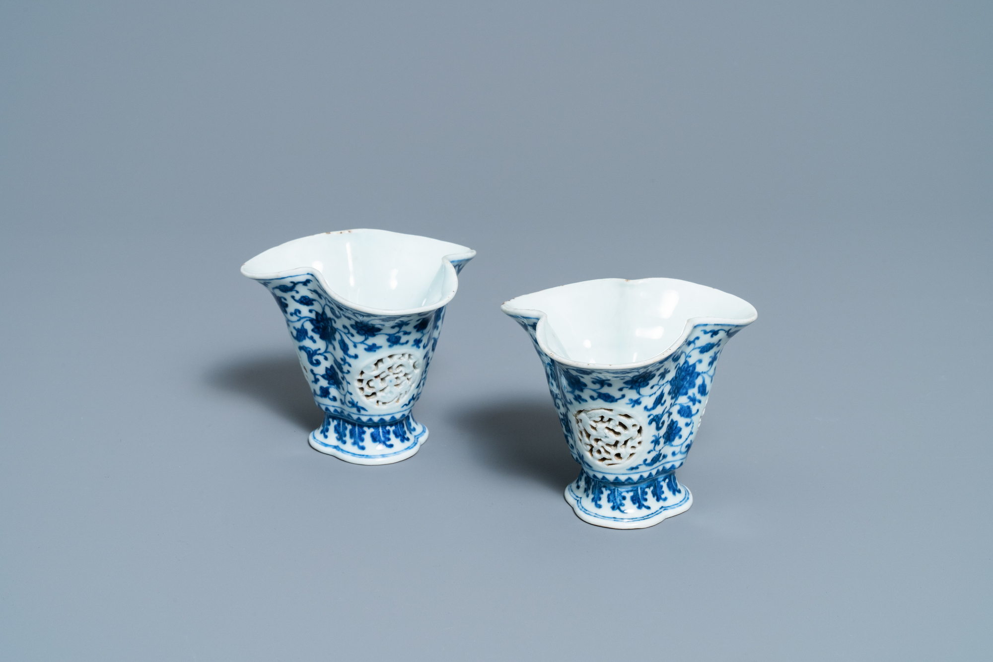 A pair of rare Chinese blue and white double-walled reticulated trilobed libation cups, Qianlong