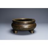 A Chinese parcel-gilt bronze tripod censer, Xuande merk, Qing