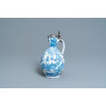 A large Dutch Delft blue and white chinoiserie jug with pewter cover, 17th C.