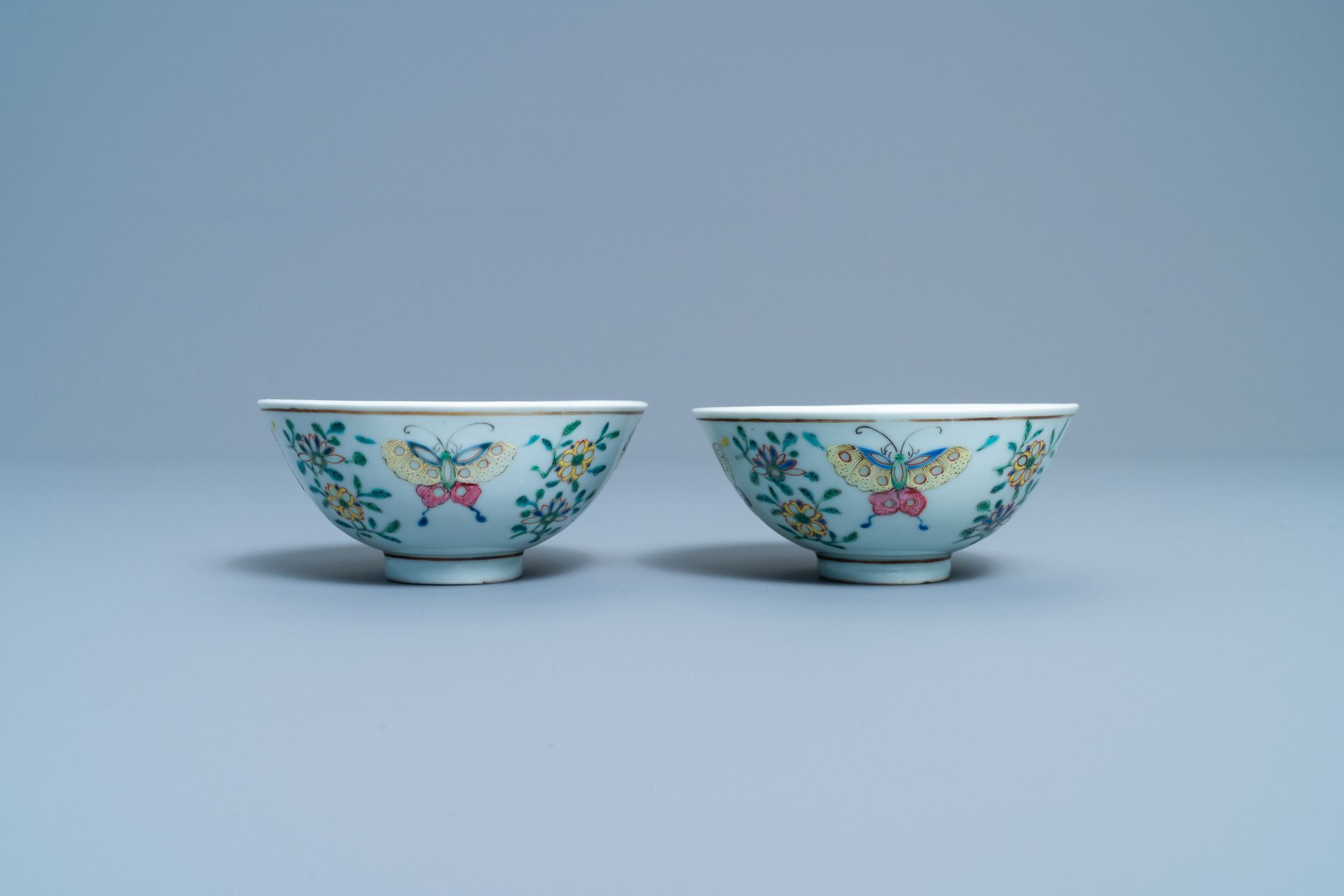 A pair of Chinese famille rose rice grain pattern 'butterfly' bowls, Qianlong mark, 19th C. - Image 3 of 10