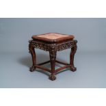 A Chinese carved wooden stand with marble top, 19th C.