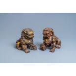 A pair of large Chinese gilt-lacquered iron models of Buddhist lions, 18/19th C.