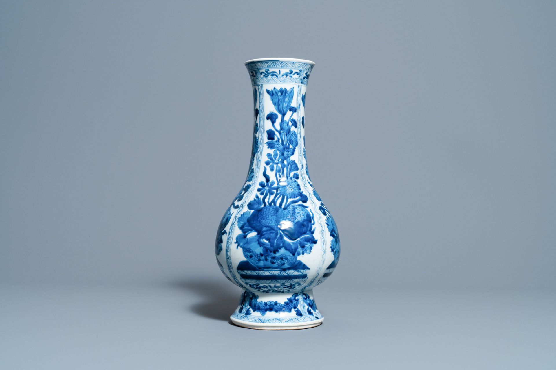 A Chinese blue and white bottle vase with flower arrangements, Kangxi