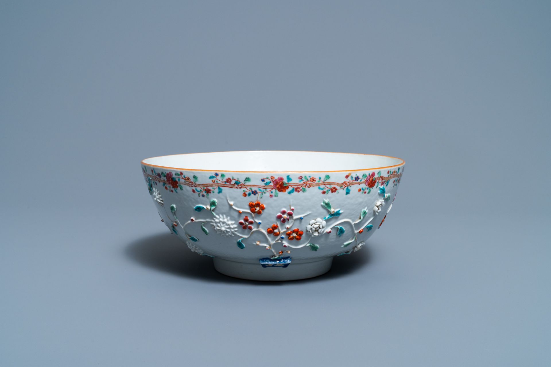 A Chinese famille rose relief-decorated floral bowl, Yongzheng/Qianlong