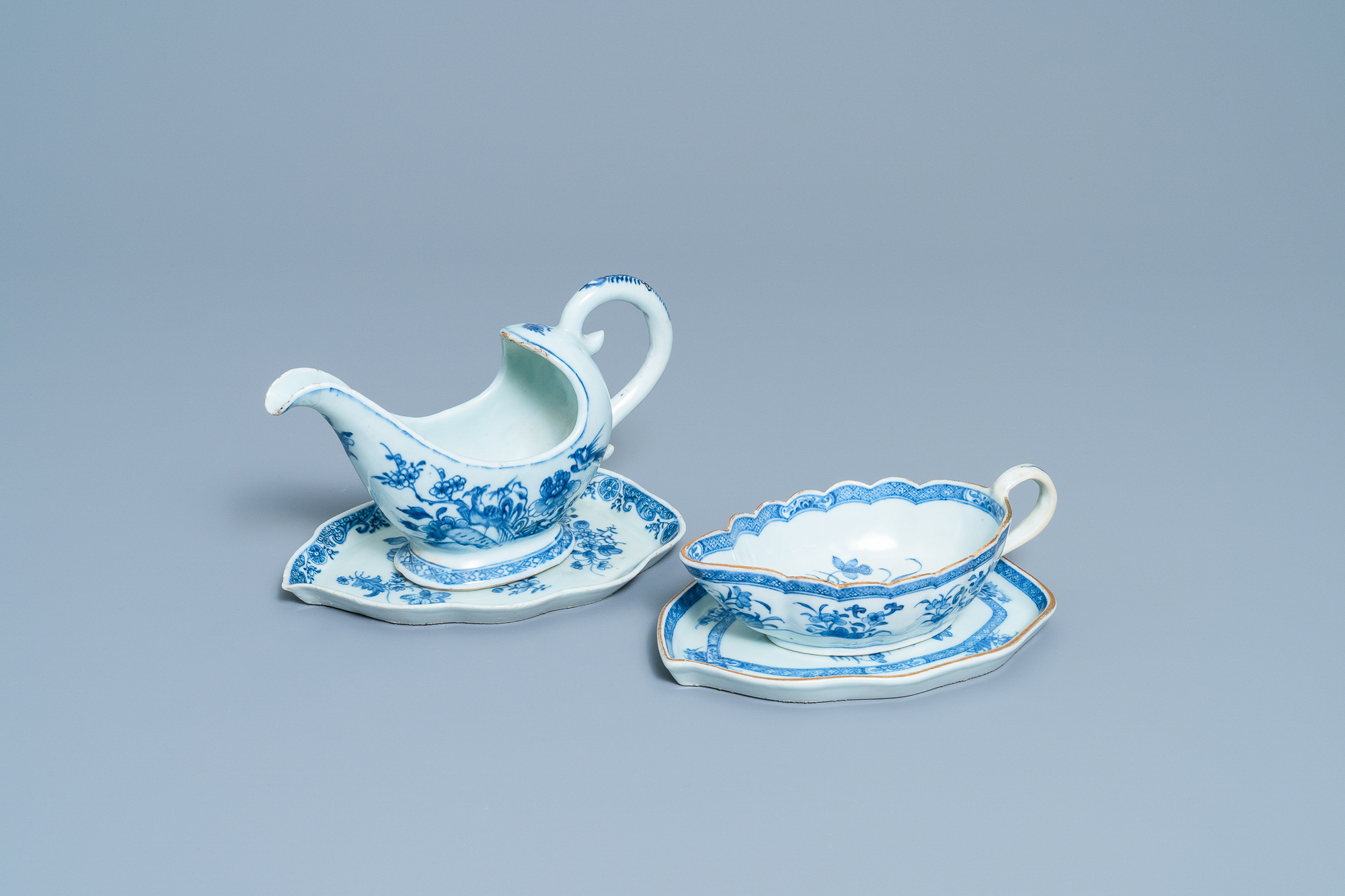 Two Chinese blue and white sauceboats on stands, Qianlong