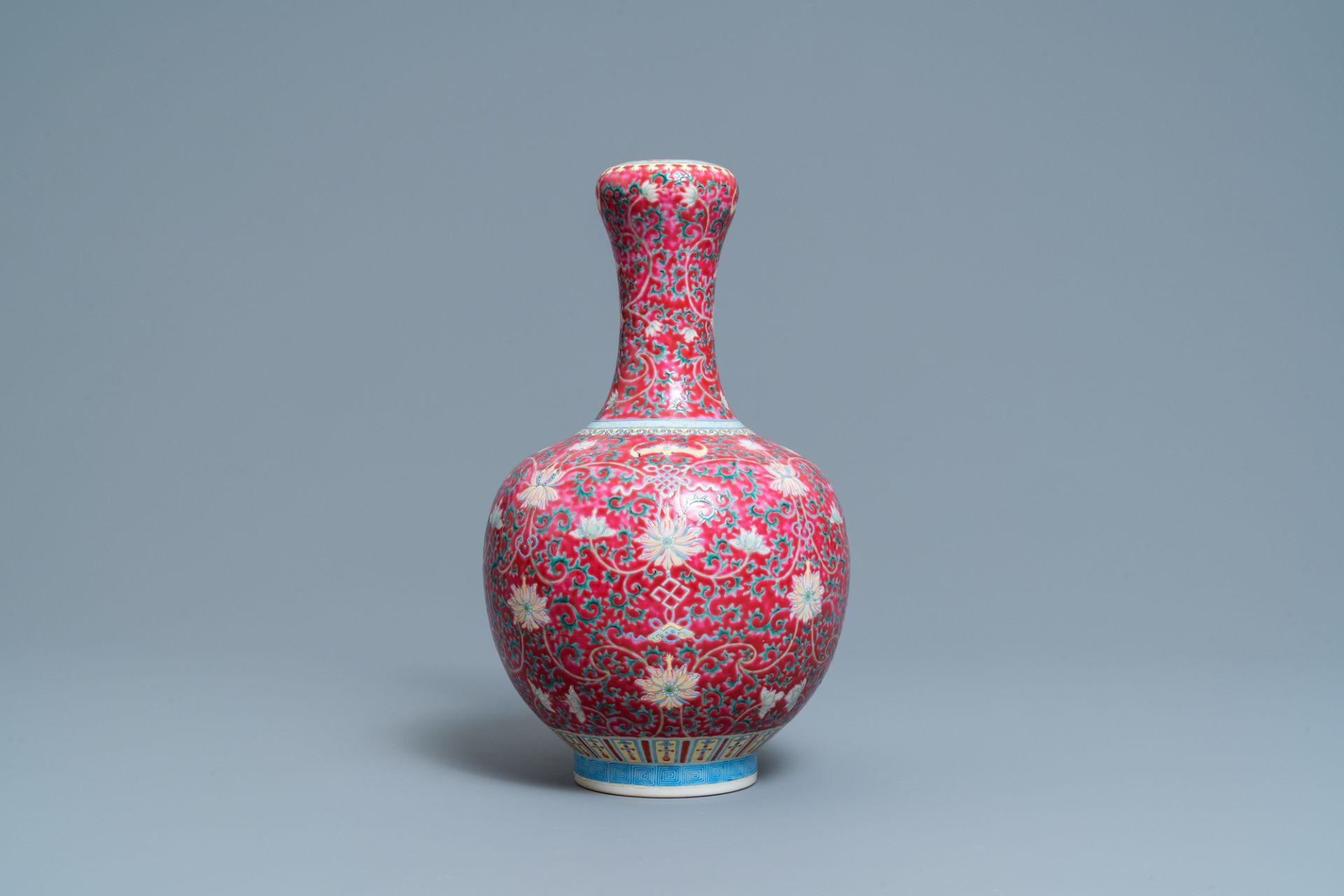 A Chinese famille rose ruby-ground bottle vase, Qianlong mark, 19/20th C. - Image 2 of 6