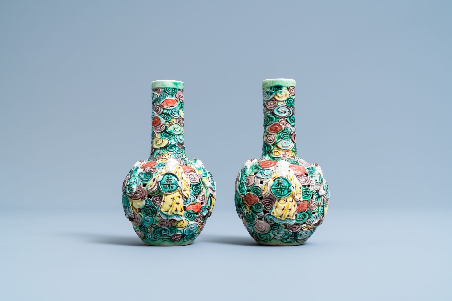 A pair of Chinese reticulated famille verte bottle vases, 19th C.