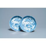 A pair of Chinese blue and white strainer dishes with ladies in a garden, Qianlong