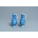 A pair of Chinese blue and white ewers and covers with floral design, Kangxi