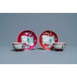 A pair of Chinese famille rose ruby-ground cups and saucers, Yongzheng