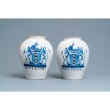 A pair of large Dutch Delft blue and white tobacco jars with the arms of Amsterdam, 18th C.