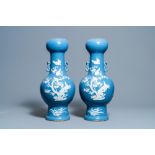 A pair of Chinese white slip-decorated blue-ground vases, 19th C.