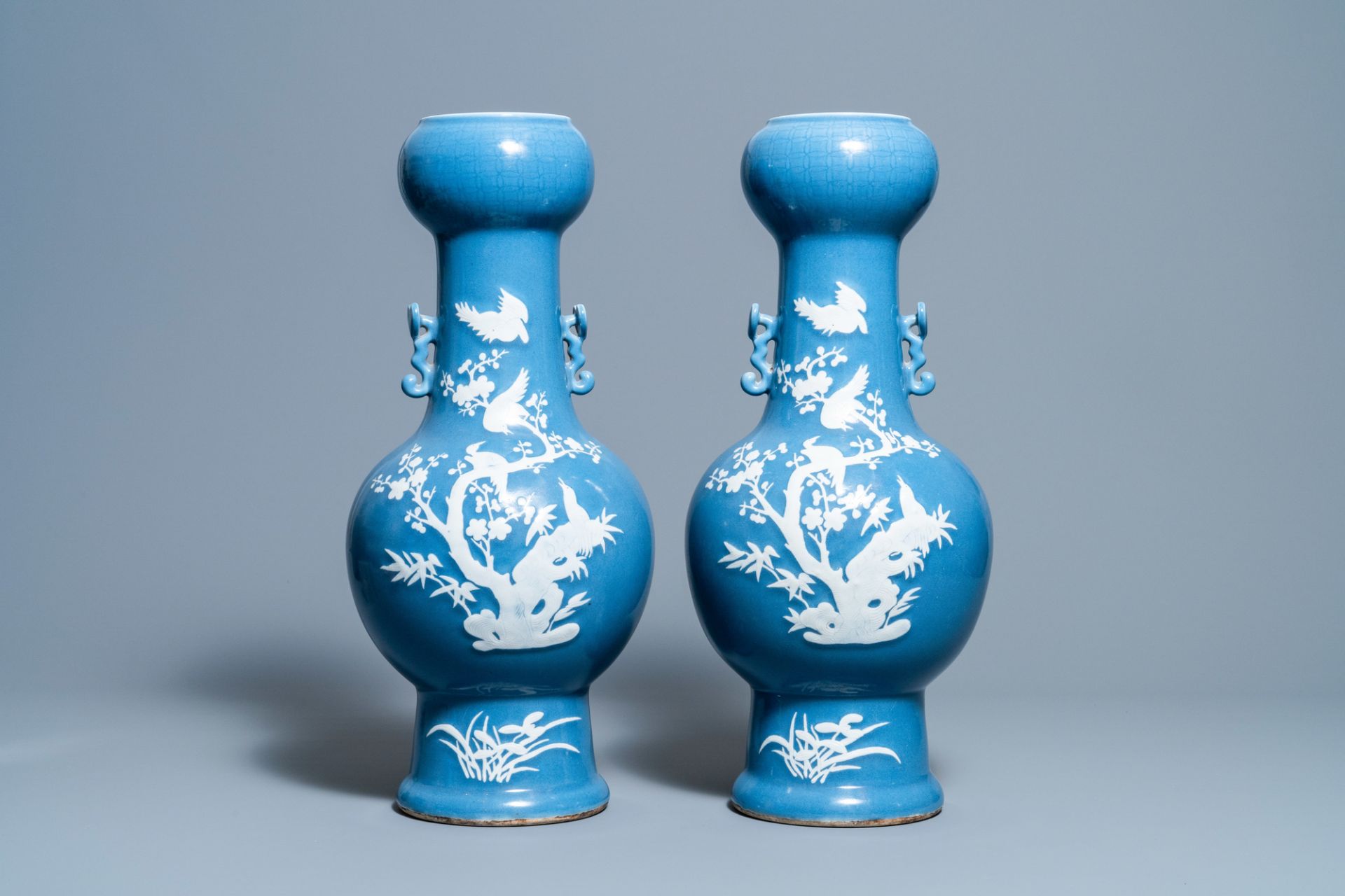 A pair of Chinese white slip-decorated blue-ground vases, 19th C.